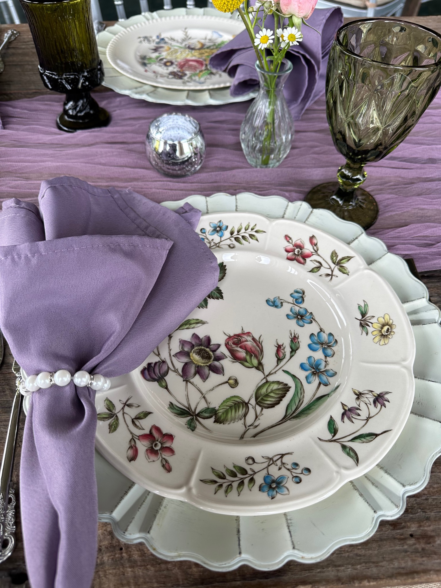 Vintage floral place setting with lavender napkin and green glassware